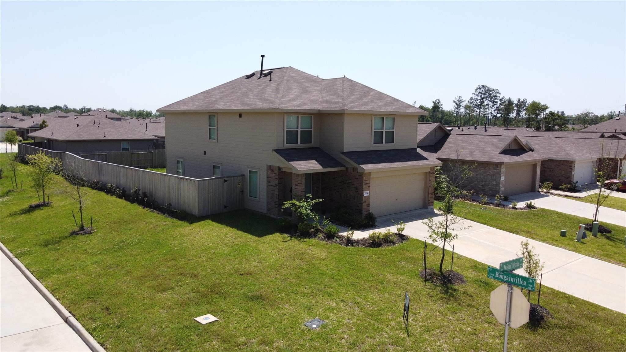 3034 Twisted Myrtle Drive Conroe, TX 77301 - Photo 26 of 27 a front view of a house with a yard