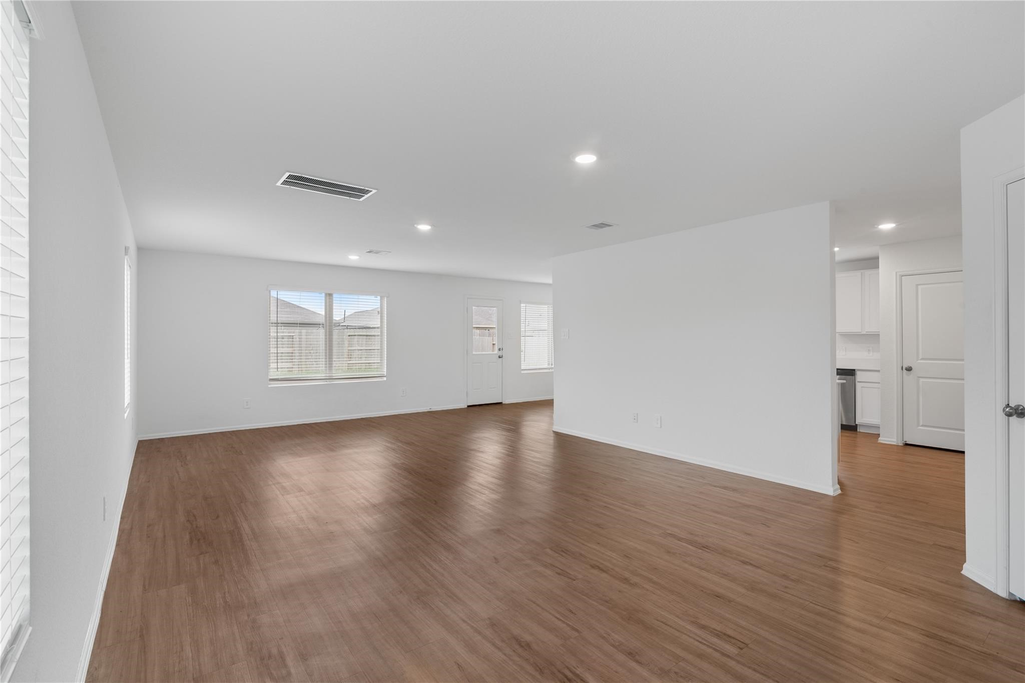 3034 Twisted Myrtle Drive Conroe, TX 77301 - Photo 3 of 27 an empty room with wooden floor and windows