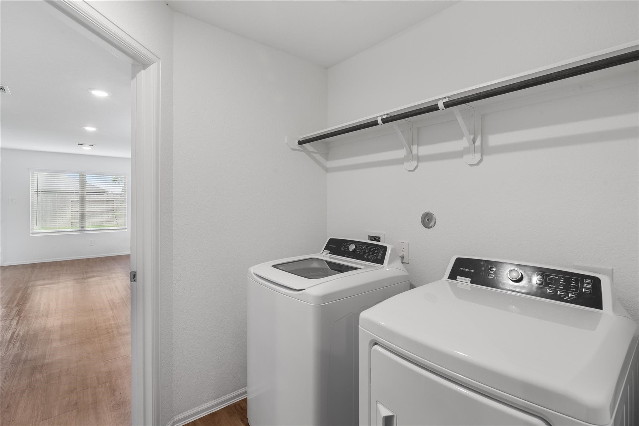 3034 Twisted Myrtle Drive Conroe, TX 77301 - Photo 9 of 27 a view of storage and utility room with washer and dryer