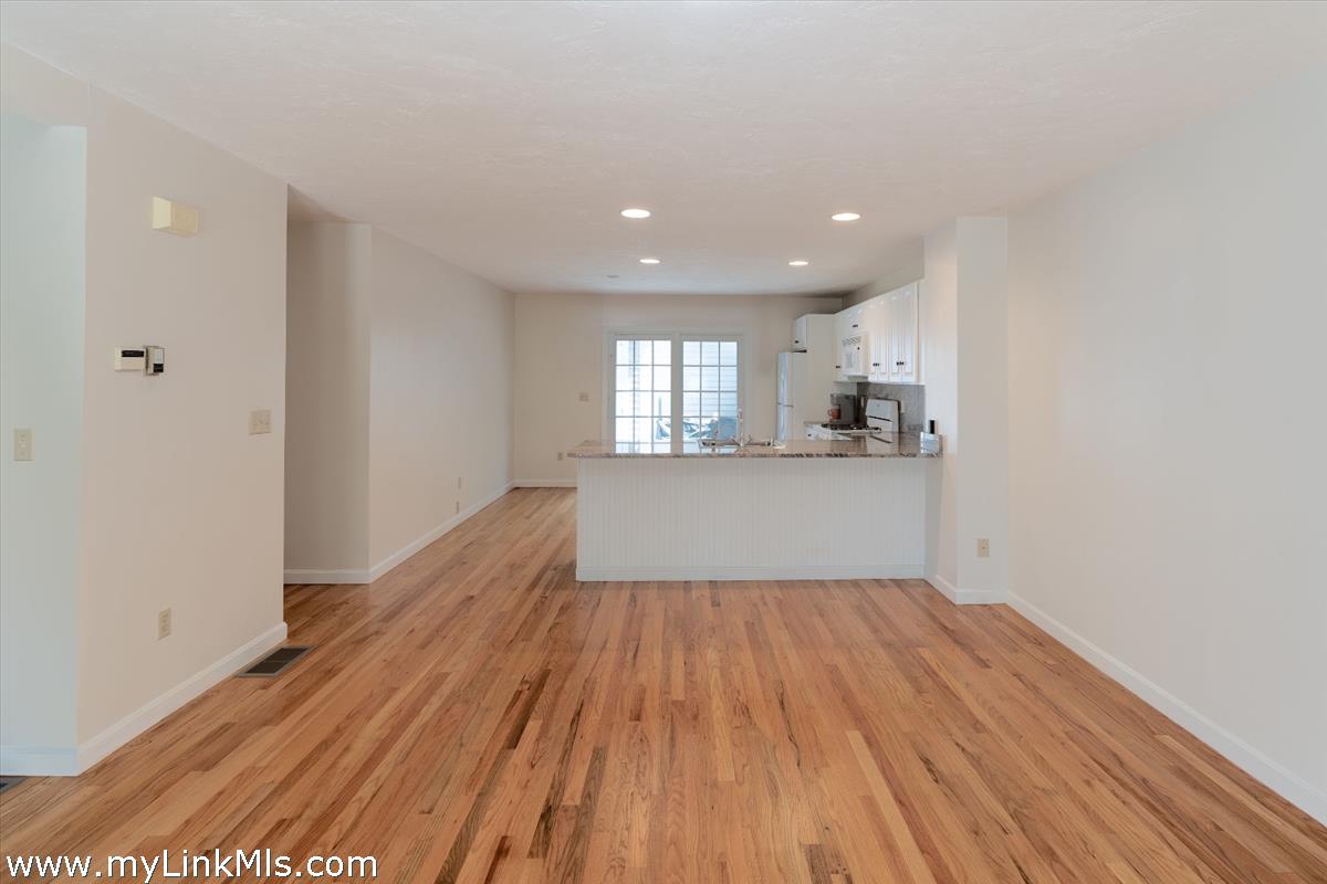 261 Sandpiper Lane, Unit 12 Vineyard Haven, MA 02568 - Photo 13 of 50 a view of a kitchen with wooden floor and a sink