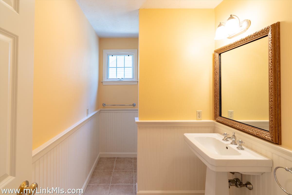 261 Sandpiper Lane, Unit 12 Vineyard Haven, MA 02568 - Photo 16 of 50 a bathroom with a sink and a mirror