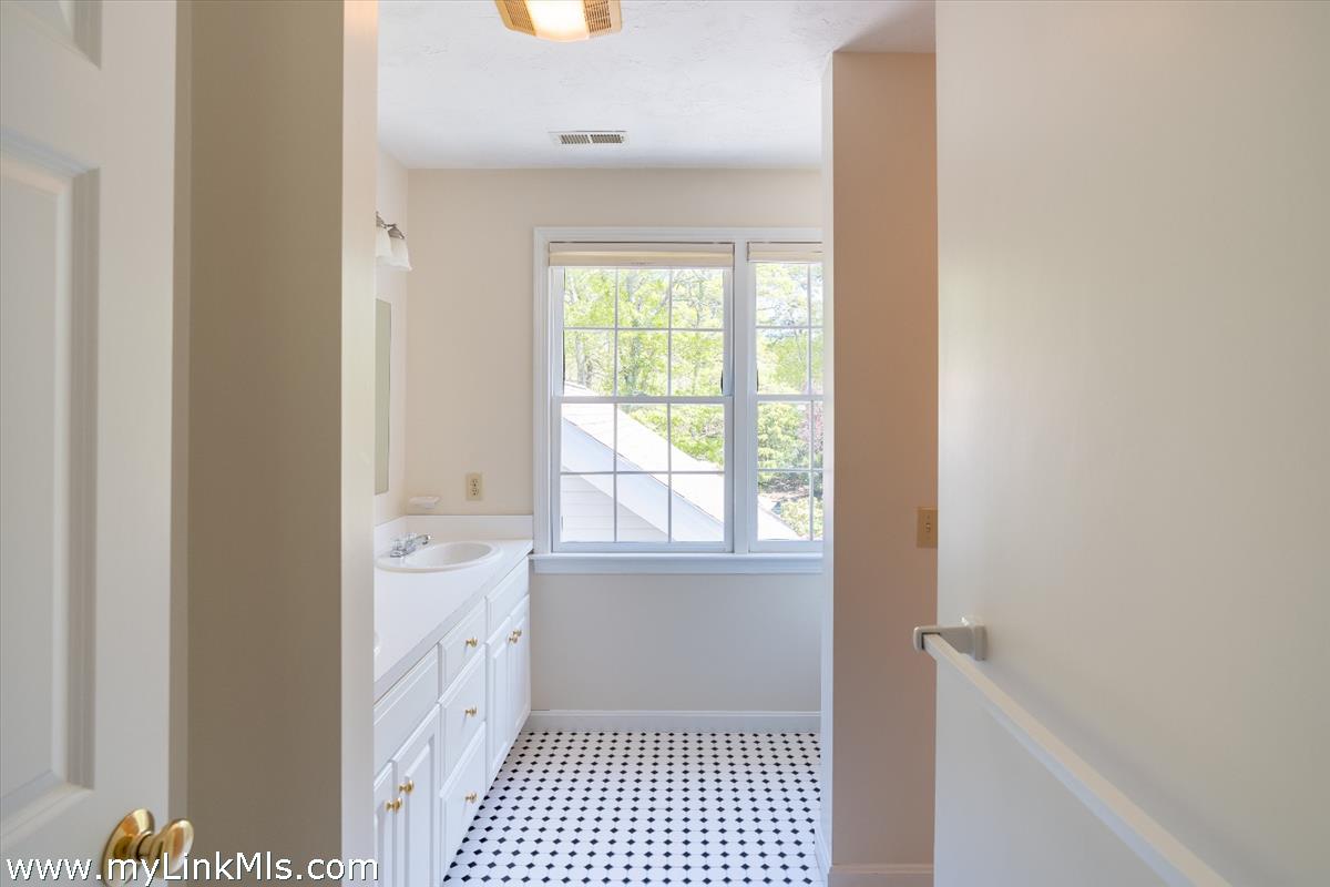 261 Sandpiper Lane, Unit 12 Vineyard Haven, MA 02568 - Photo 22 of 50 a bathroom with a sink a toilet a window and vanity
