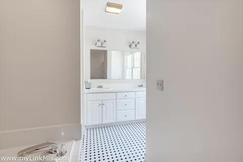 a bathroom with a sink a toilet and a mirror