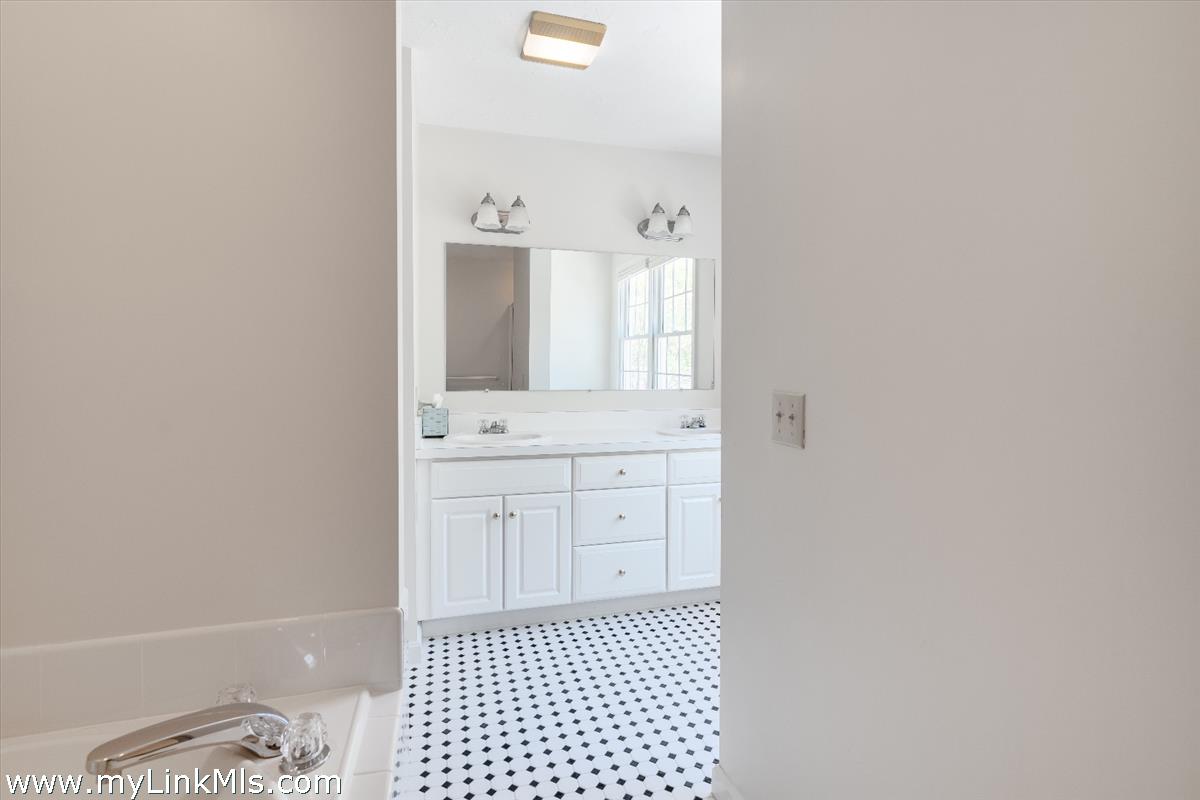 261 Sandpiper Lane, Unit 12 Vineyard Haven, MA 02568 - Photo 24 of 50 a bathroom with a sink a toilet and a mirror