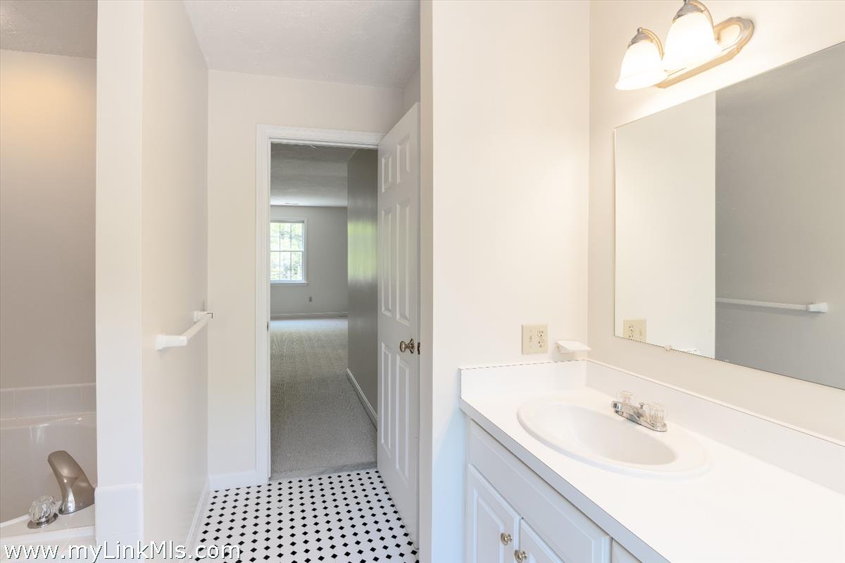 261 Sandpiper Lane, Unit 12 Vineyard Haven, MA 02568 - Photo 26 of 50 a bathroom with a sink and a mirror