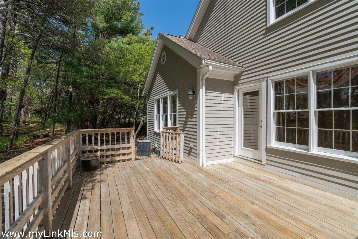 261 Sandpiper Lane, Unit 12 Vineyard Haven, MA 02568 - Photo 31 of 50 a view of deck with a barbeque and wooden stairs