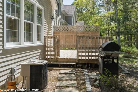 a view of a backyard with wooden floor and fence