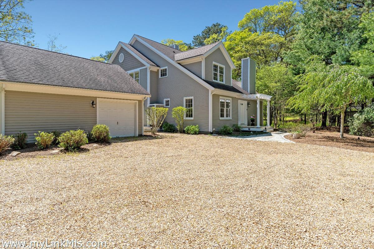 261 Sandpiper Lane, Unit 12 Vineyard Haven, MA 02568 - Photo 48 of 50 a front view of a house with garden
