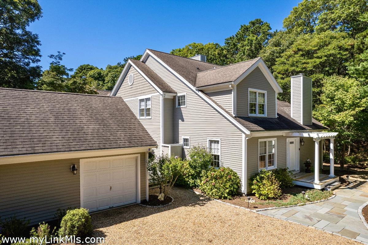261 Sandpiper Lane, Unit 12 Vineyard Haven, MA 02568 - Photo 49 of 50 a front view of a house with a yard