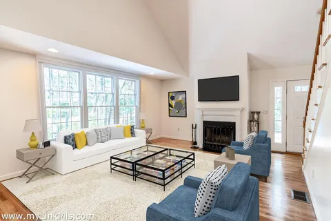 a living room with furniture fireplace and a flat screen tv