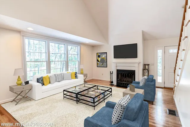 a living room with furniture fireplace and a flat screen tv