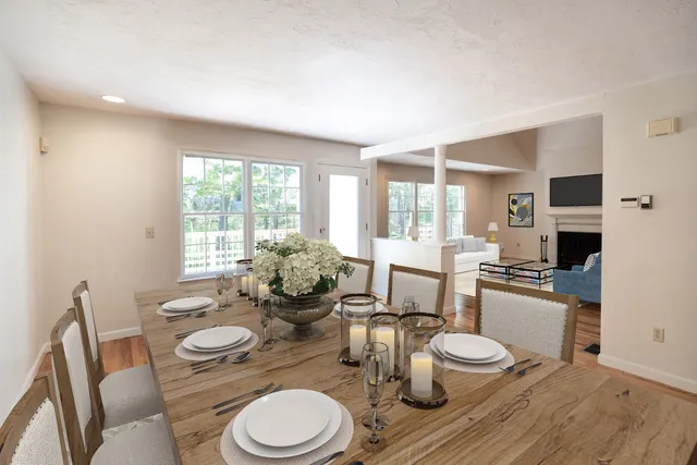 a dining room with furniture a large window and wooden floor