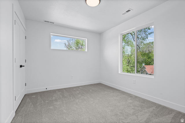 340 East 7635 S Street Sandy, UT 84047 - Photo 20 of 32 Spare room with light colored carpet and baseboards
