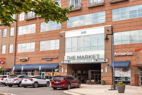 a view of a cars park in front of a building