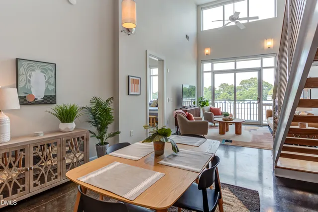 a dining room with furniture window and wooden floor