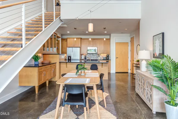 a dining room with furniture and a floor to ceiling window