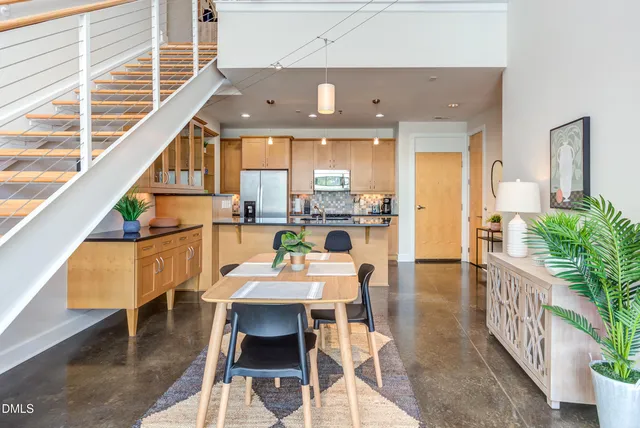 a dining room with furniture and a floor to ceiling window