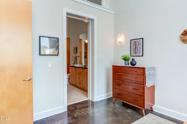 a spacious bathroom with a double vanity sink a toilet a mirror and a bathtub