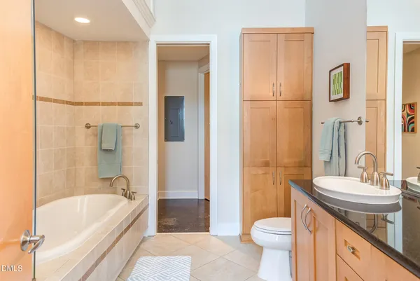 a bathroom with a double vanity sink toilet and shower