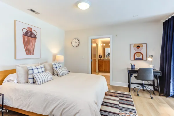 a bedroom with a bed and a desk