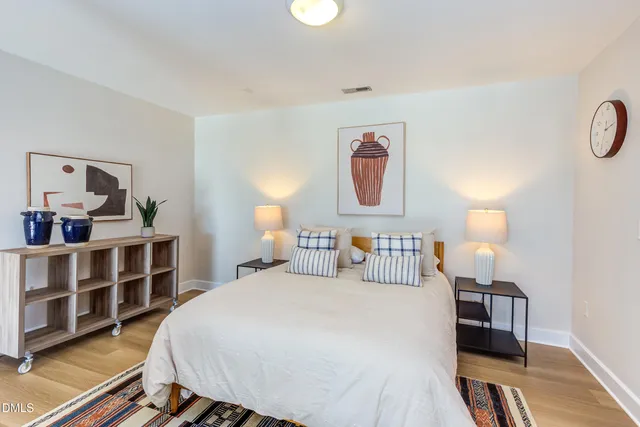 a bedroom with furniture and a large mirror