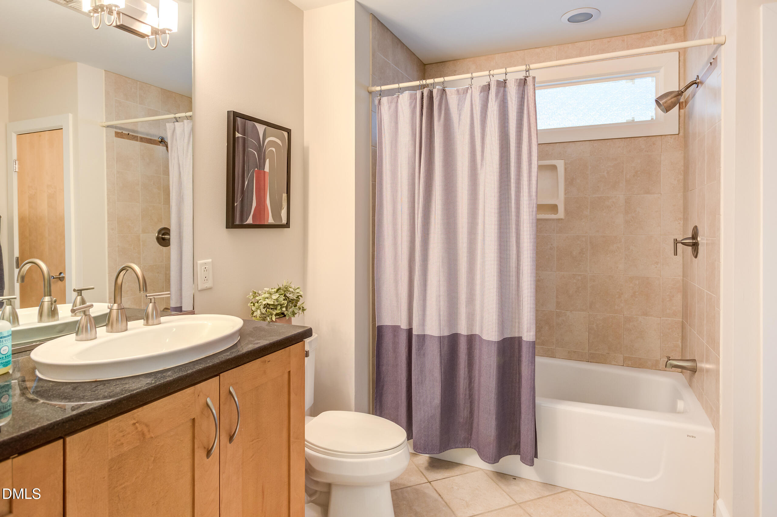 2608 Erwin Road, Unit 417 Durham, NC 27705 - Photo 36 of 50 a bathroom with a sink a toilet a mirror and shower