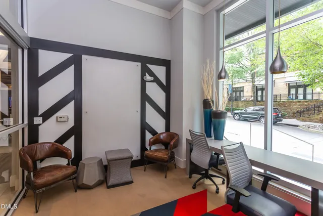 a room with stainless steel appliances wooden floor and chandelier