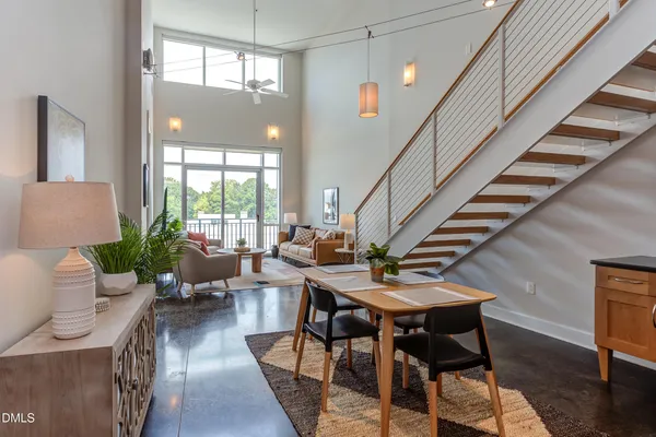 a kitchen with stainless steel appliances granite countertop a stove a sink dishwasher a refrigerator and cabinets with wooden floor