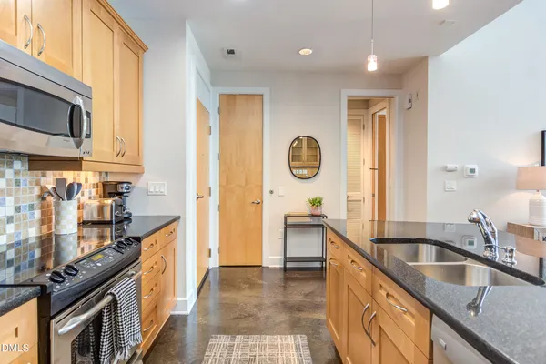a living room with granite countertop furniture and a wooden floor