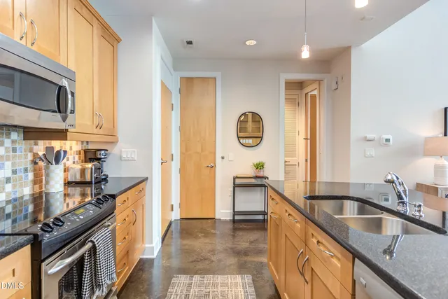 a living room with granite countertop furniture and a wooden floor