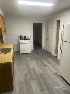 79 Chestnut Street Winchester, CT 06098 - Photo 2 of 10 a room with a couch and a stove top oven