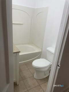 79 Chestnut Street Winchester, CT 06098 - Photo 5 of 10 a white toilet sitting next to a bath tub