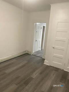 79 Chestnut Street Winchester, CT 06098 - Photo 6 of 10 an empty room with a bench