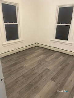 79 Chestnut Street Winchester, CT 06098 - Photo 9 of 10 a view of an empty room with wooden floor and a window