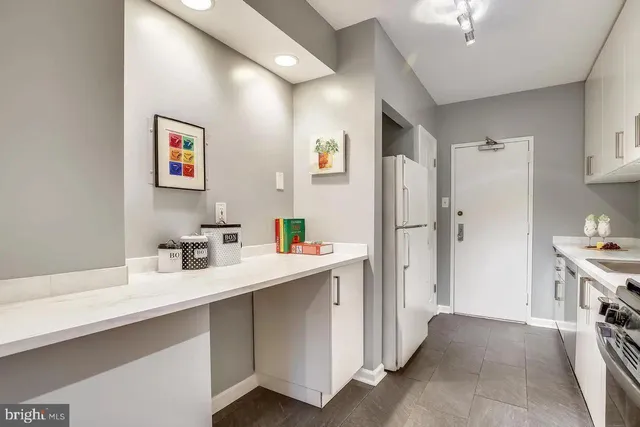 a kitchen with stainless steel appliances a refrigerator and a sink