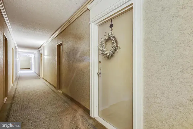 a view of a hallway with wooden shelves