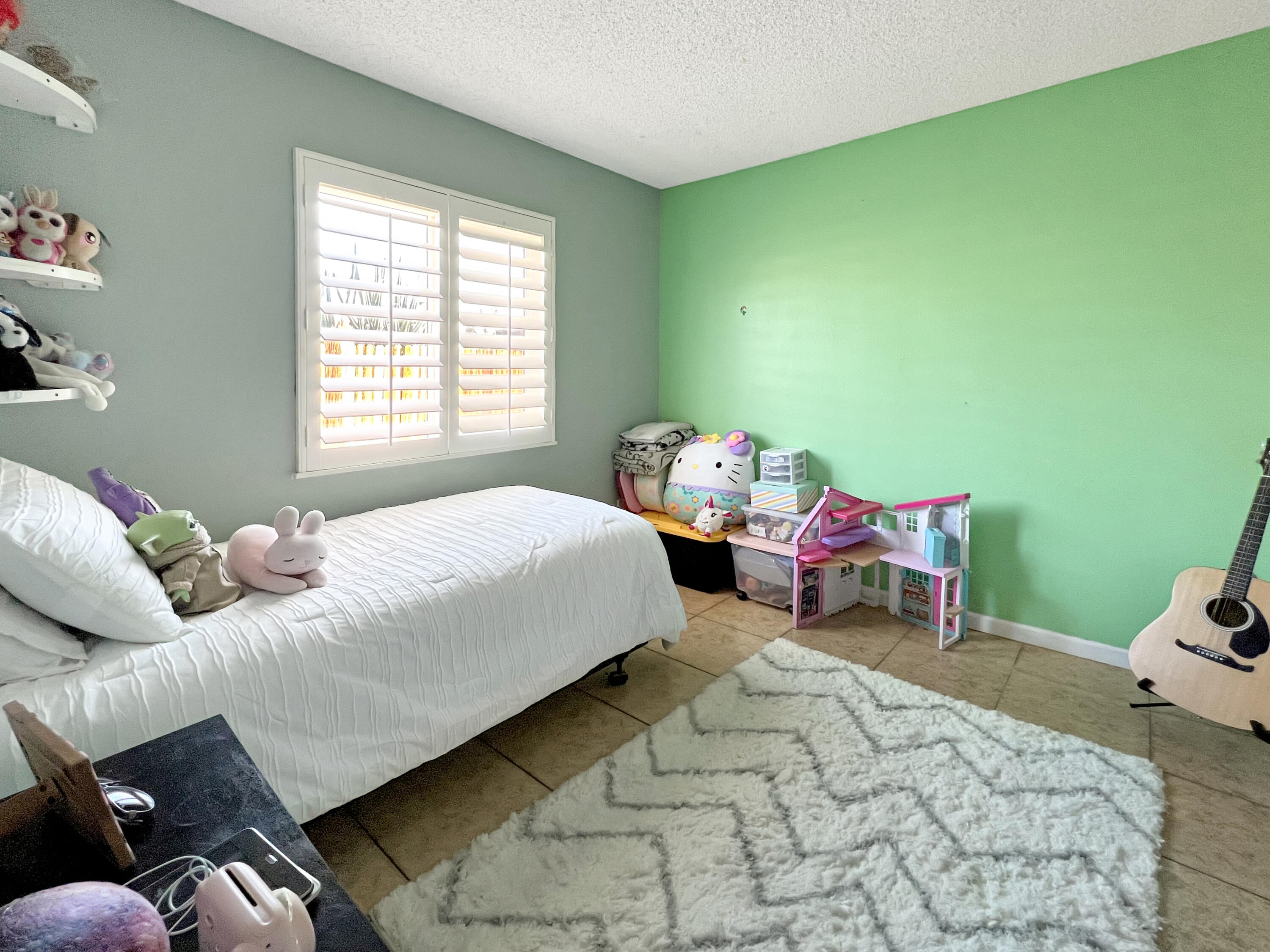 44590 Roundtable Street Indio, CA 92201 - Photo 12 of 16 a bedroom with a bed chair and a window