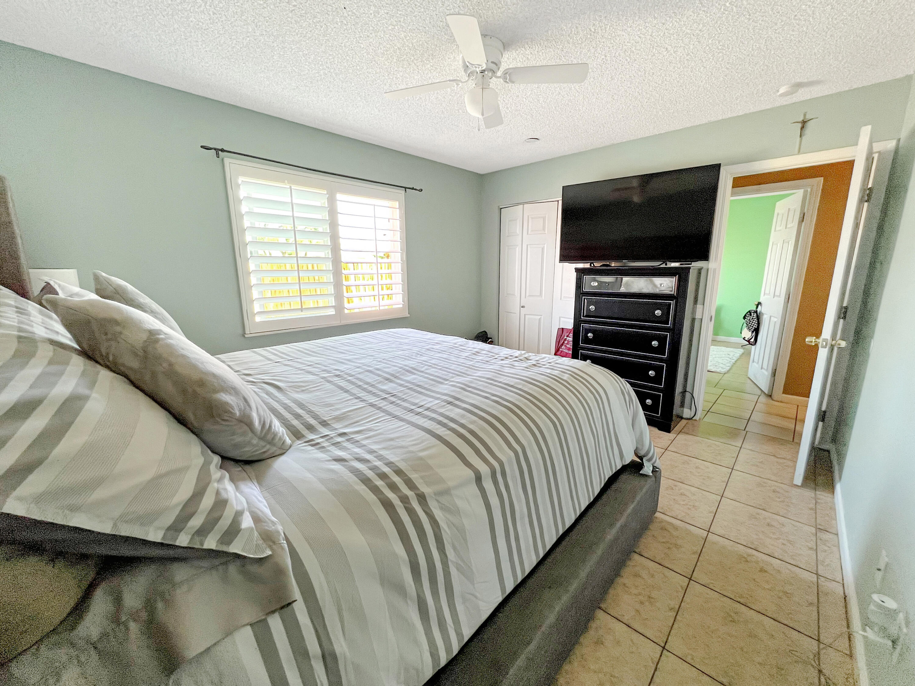 44590 Roundtable Street Indio, CA 92201 - Photo 13 of 16 a bedroom with a bed and a flat screen tv