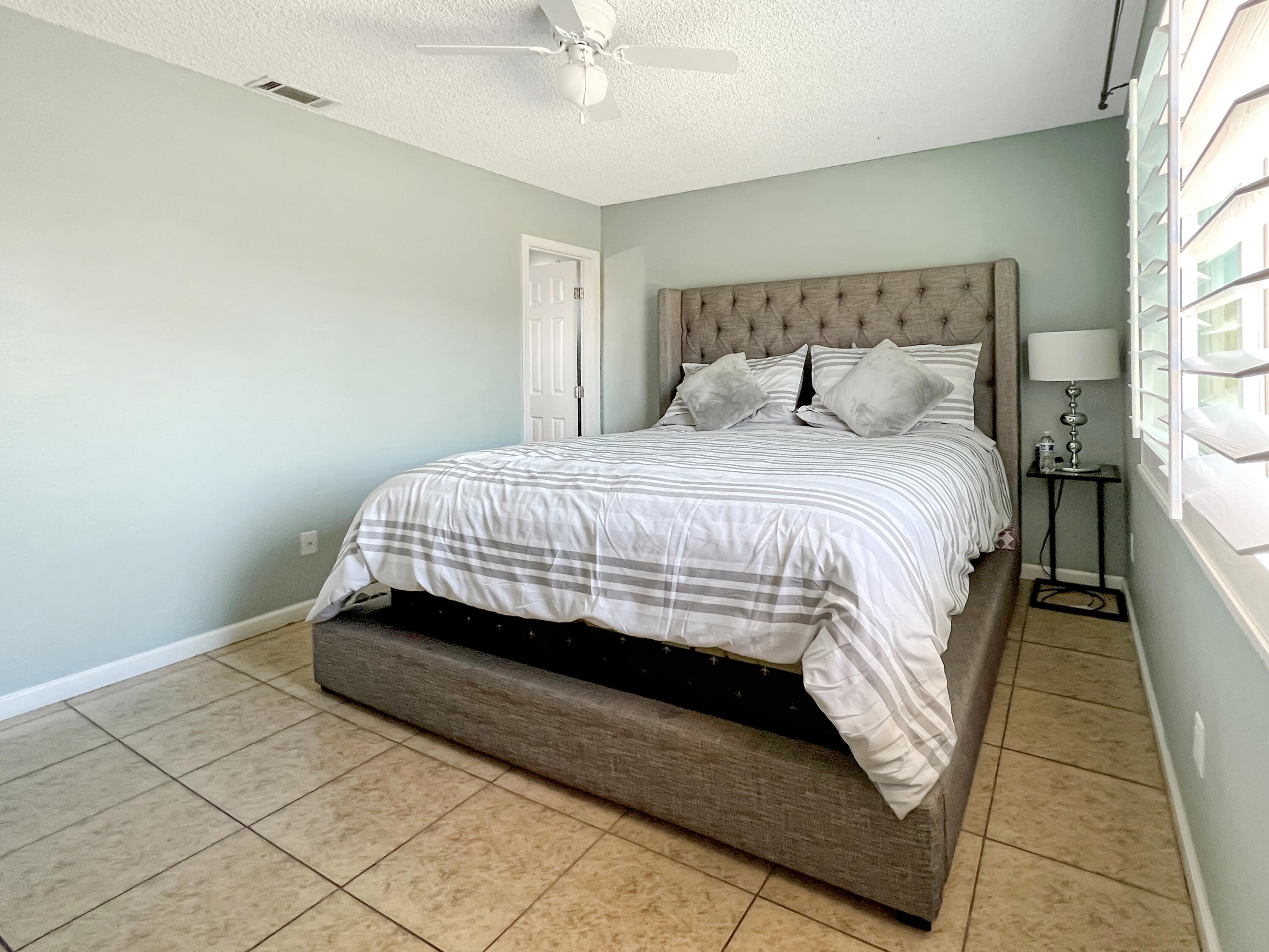 44590 Roundtable Street Indio, CA 92201 - Photo 14 of 16 a bedroom with a bed and window