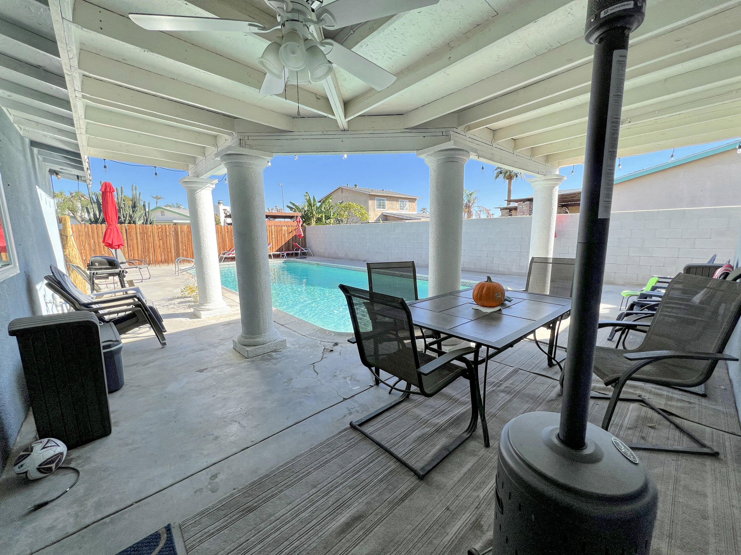 44590 Roundtable Street Indio, CA 92201 - Photo 16 of 16 a view of a dining room with furniture a chandelier and wooden floor
