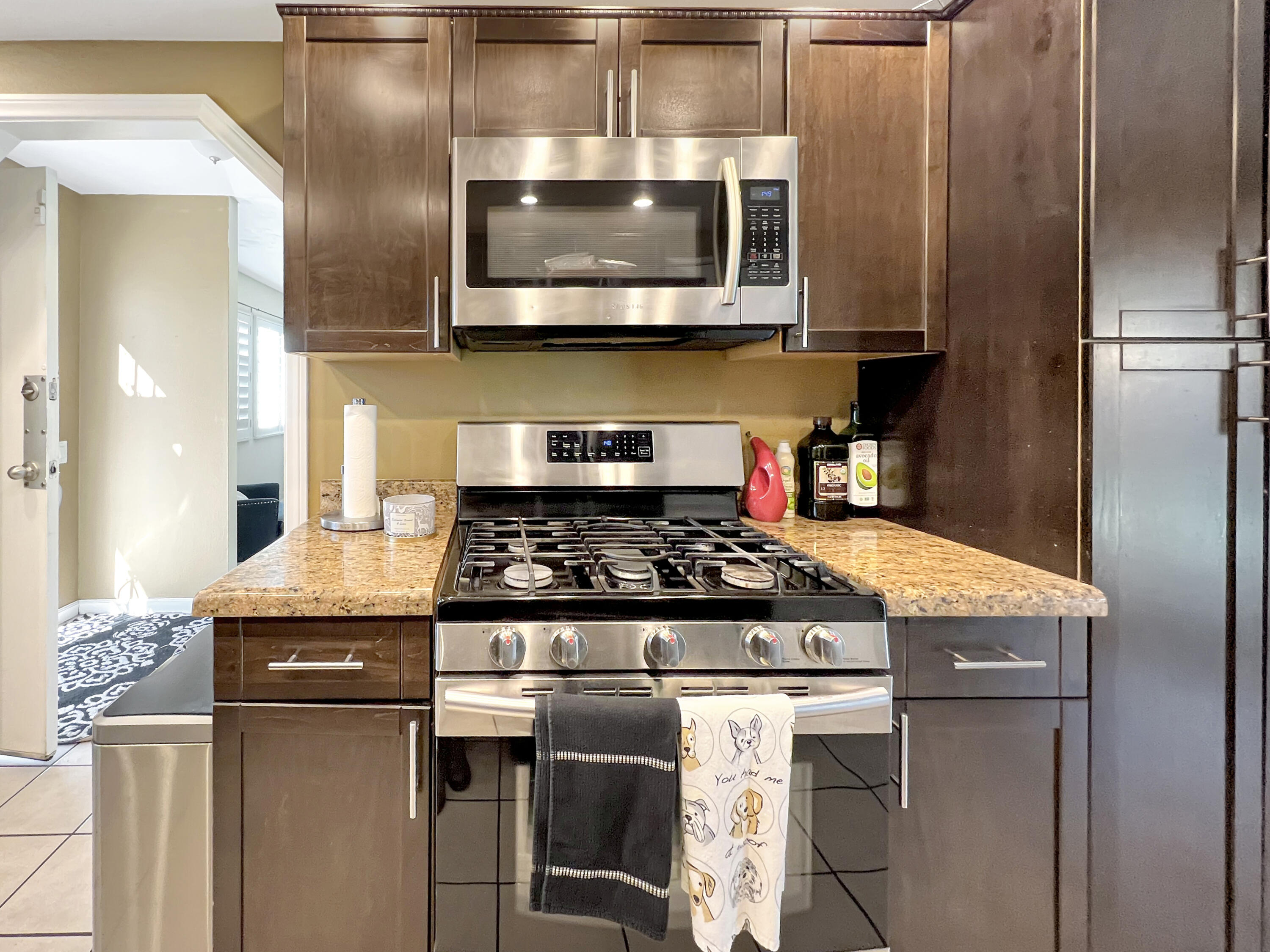 44590 Roundtable Street Indio, CA 92201 - Photo 6 of 16 a kitchen with granite countertop a stove and a microwave