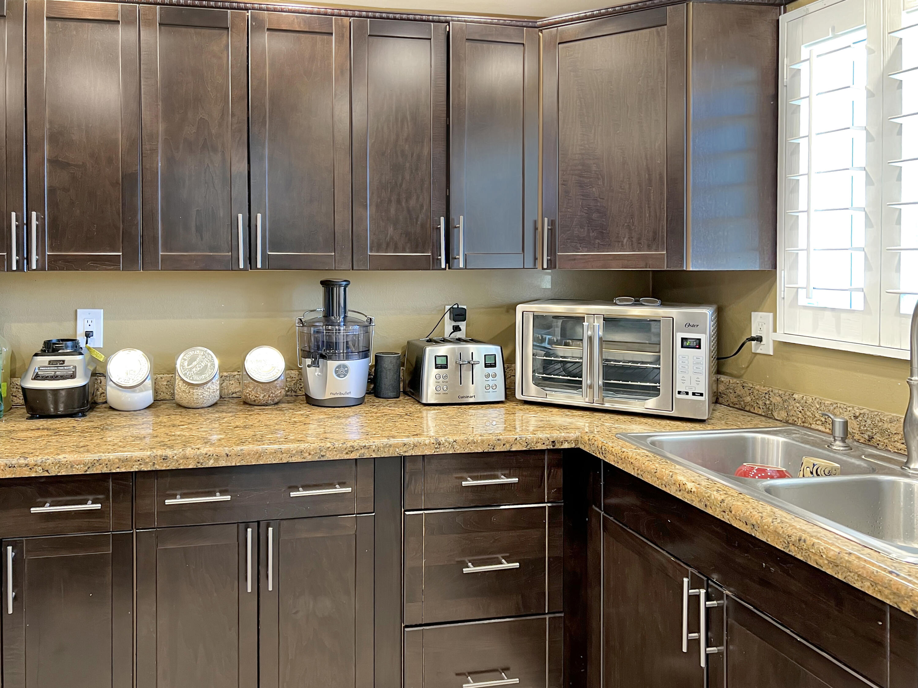 44590 Roundtable Street Indio, CA 92201 - Photo 7 of 16 a kitchen with granite countertop stainless steel appliances wooden cabinets and a sink