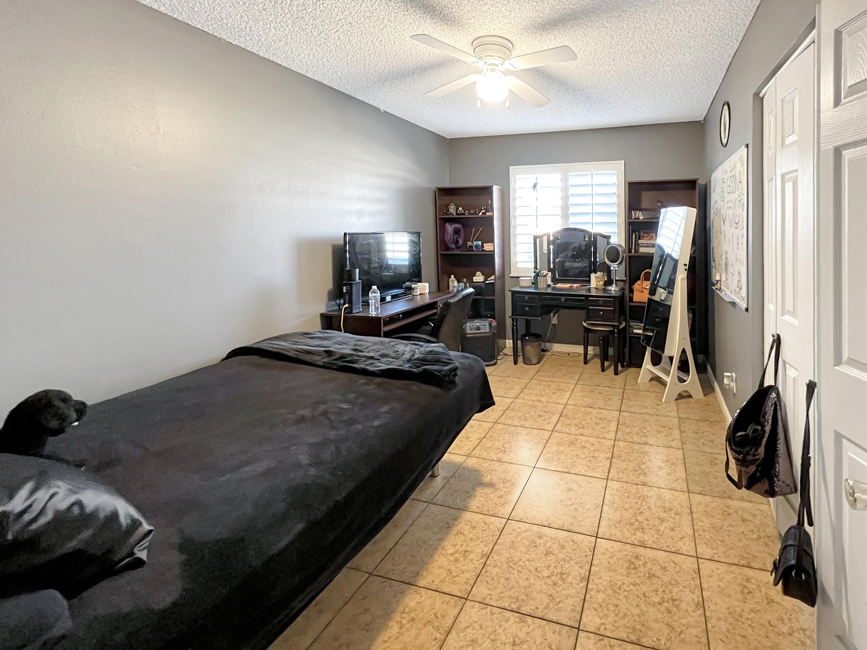 44590 Roundtable Street Indio, CA 92201 - Photo 9 of 16 a bedroom with a bed and a chandelier