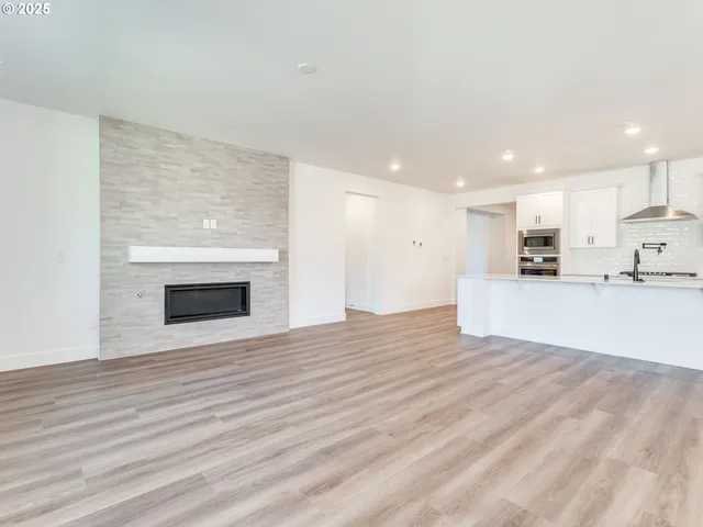 a view of a kitchen with a sink and wooden floor