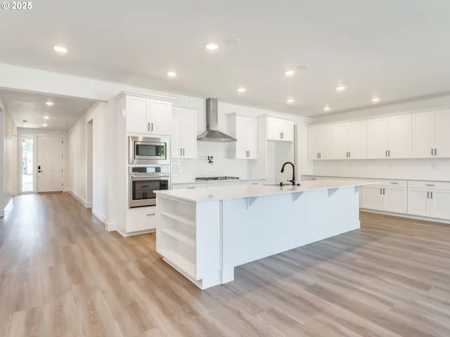 a kitchen with granite countertop a sink stove and cabinets