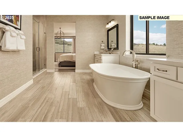 a spacious bedroom with a bed and a large window