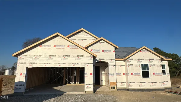 a view of a house with wooden fence