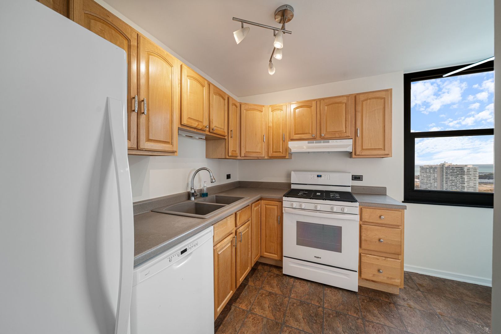 2605 South Indiana Avenue, Unit 2107 Chicago, IL 60616 - Photo 12 of 24 a kitchen with a stove sink and cabinets