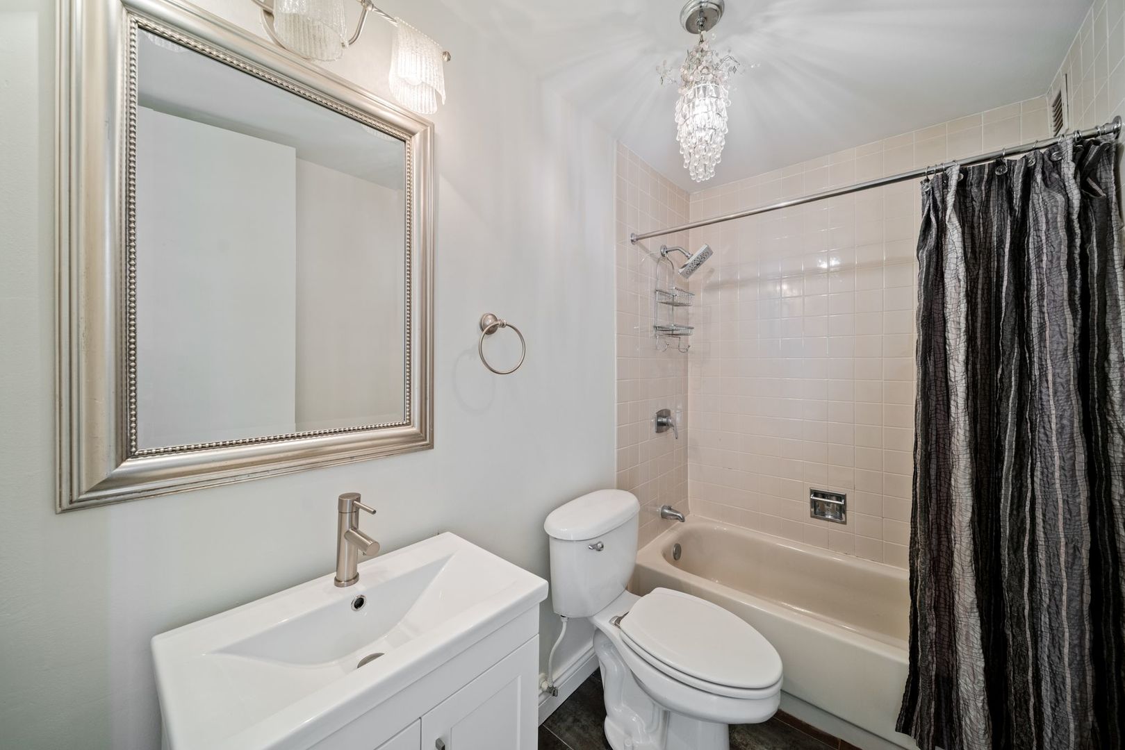 2605 South Indiana Avenue, Unit 2107 Chicago, IL 60616 - Photo 18 of 24 a bathroom with a sink toilet and shower