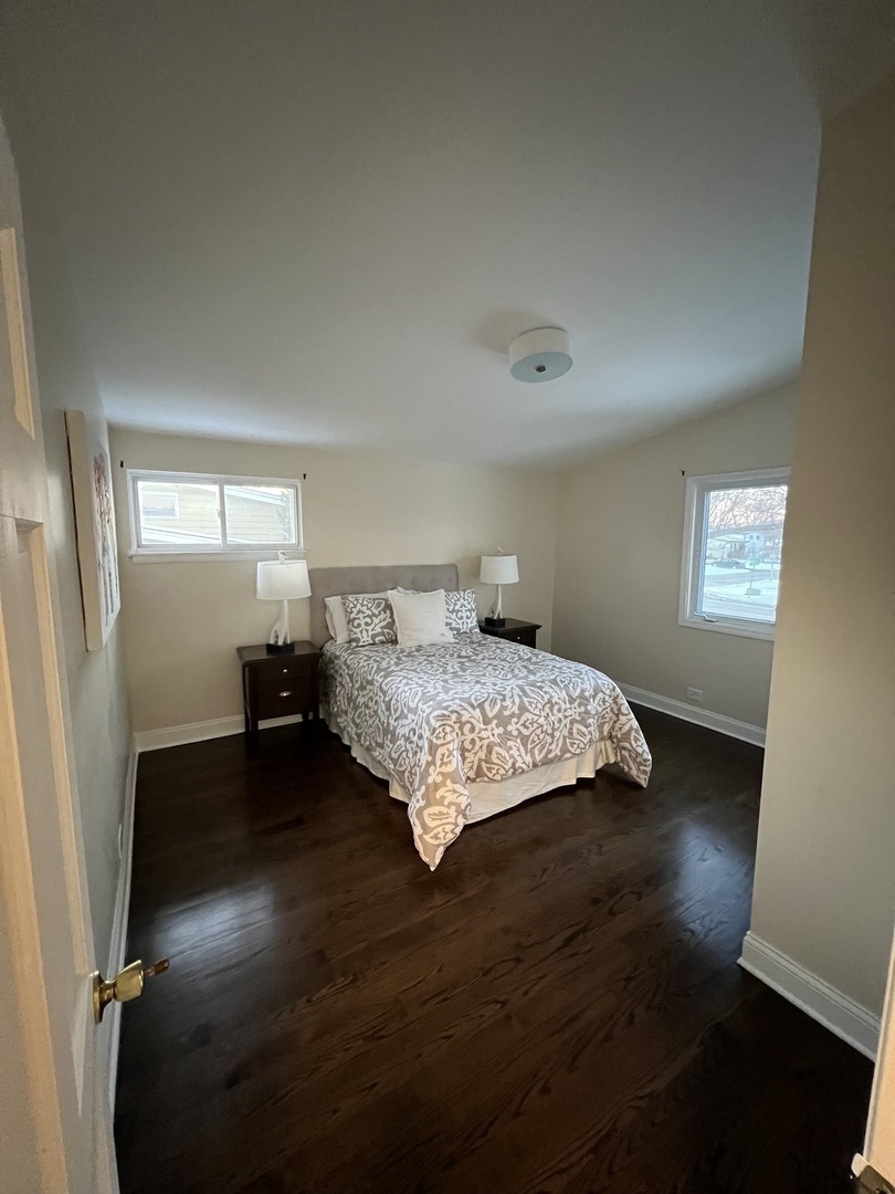 2933 Central Road Glenview, IL 60025 - Photo 19 of 38 a bedroom with a bed and wooden floor